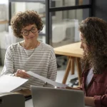 Professional lady mentoring younger colleague